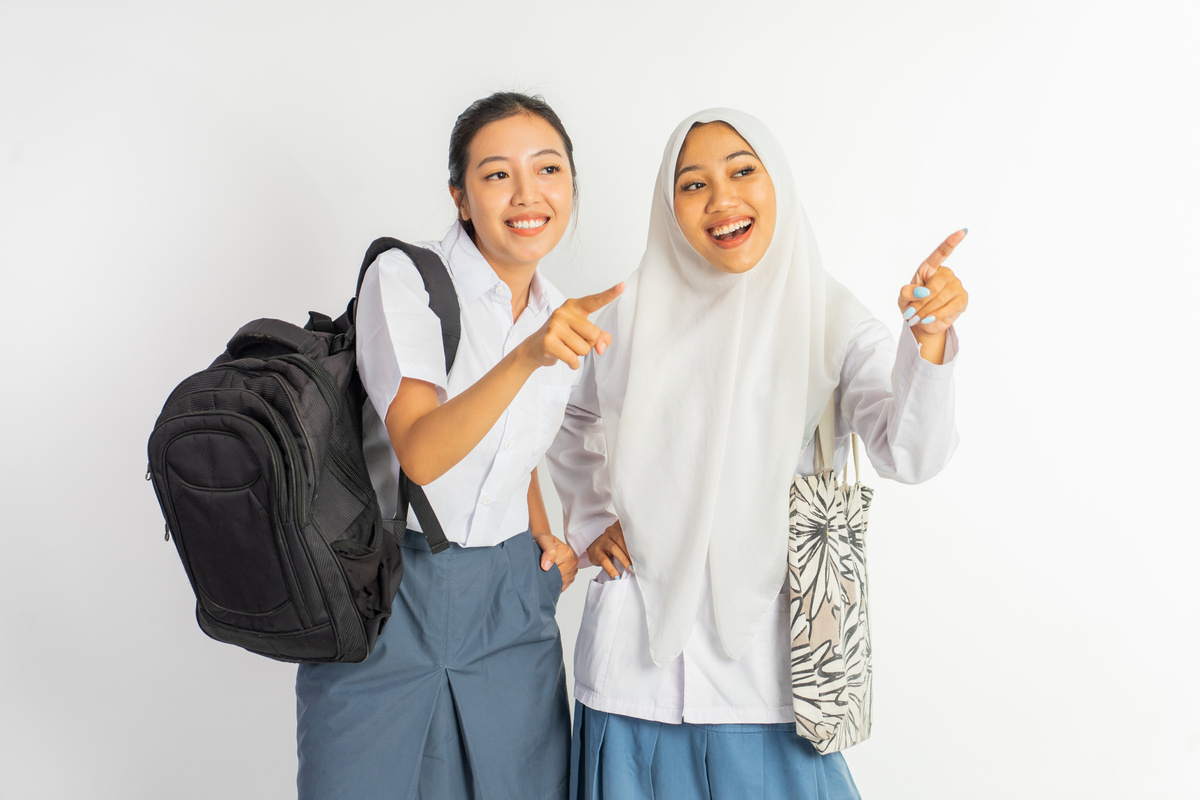 Two Vocational High School Girls Smiling with Finger Pointing